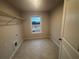 Small laundry room with shelving and tile flooring provides functionality at 337 Willow Cv, Canton, GA 30114