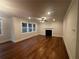 Spacious living room featuring hardwood floors, fireplace, and multiple windows at 337 Willow Cv, Canton, GA 30114