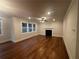 Cozy living room with hardwood floors, a fireplace, and large windows offering natural light at 337 Willow Cv, Canton, GA 30114