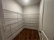 Walk-in pantry with metal shelving and wood floor offers ample storage at 337 Willow Cv, Canton, GA 30114