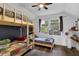 Bedroom featuring a bunkbed, an accent wall, hardwood floors, and a window at 751 San Fernando Se Dr, Smyrna, GA 30080