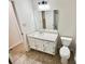 Clean bathroom features a vanity, toilet, mirror, and updated plumbing fixtures at 211 Murphy Ave, Lawrenceville, GA 30044