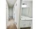 Hallway view of a clean bathroom with a vanity and large mirror at 211 Murphy Ave, Lawrenceville, GA 30044