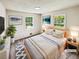 Inviting bedroom featuring two windows for natural light and hardwood floors. (Virtually Staged) at 211 Murphy Ave, Lawrenceville, GA 30044