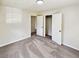Neutral bedroom features plush carpeting and access to closet and other rooms at 211 Murphy Ave, Lawrenceville, GA 30044