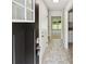 Inviting entryway with tile flooring leading to kitchen and stairs, enhanced with keyless entry at 211 Murphy Ave, Lawrenceville, GA 30044
