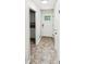 Inviting hallway with neutral colors leading to a bright entrance featuring tile flooring and white front door at 211 Murphy Ave, Lawrenceville, GA 30044