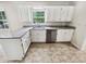 Well-lit kitchen features stainless steel appliances, granite counters, and stylish flooring at 211 Murphy Ave, Lawrenceville, GA 30044