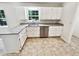 Kitchen features stainless steel dishwasher, granite countertops and white cabinets at 211 Murphy Ave, Lawrenceville, GA 30044