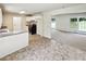 Kitchen with white cabinets and black appliances flows into living area at 211 Murphy Ave, Lawrenceville, GA 30044