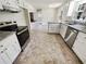 Renovated kitchen with granite counters, stainless appliances and white cabinets at 211 Murphy Ave, Lawrenceville, GA 30044