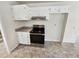 Updated kitchen includes stainless steel stove, modern vent hood, and light countertops at 211 Murphy Ave, Lawrenceville, GA 30044