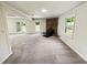Relaxing living room with a cozy brick fireplace, carpeted flooring, and sliding doors to the outside at 211 Murphy Ave, Lawrenceville, GA 30044