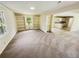 Spacious living room with built-in bookshelves, neutral walls, and carpeted floors offering an open and inviting space at 211 Murphy Ave, Lawrenceville, GA 30044