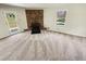 Living room with fireplace, neutral carpet, and view of the backyard at 211 Murphy Ave, Lawrenceville, GA 30044