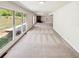 Bright living room featuring large windows with natural light, cozy carpeting, and a glimpse of a fireplace at 211 Murphy Ave, Lawrenceville, GA 30044