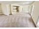 Open living area with carpeted flooring, access to a kitchen, and glass paneled doors for ample natural light at 211 Murphy Ave, Lawrenceville, GA 30044