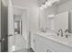 Modern bathroom featuring double sinks, white cabinets, and modern fixtures at 482 Broom Dr, Cumming, GA 30040
