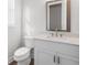 Contemporary half-bathroom with vanity, sink, a modern mirror, and sleek fixtures at 482 Broom Dr, Cumming, GA 30040