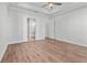 Bright bedroom showcasing hardwood floors, tray ceilings, and a doorway to the bathroom at 482 Broom Dr, Cumming, GA 30040