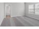 The bedroom features soft, neutral paint, plush carpeting, and a window with blinds for natural light control at 482 Broom Dr, Cumming, GA 30040