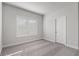 This bedroom features neutral paint, plush carpet, and natural light from a window with white blinds at 482 Broom Dr, Cumming, GA 30040