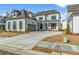 Charming two-story home with gray siding, well-manicured lawn, and a spacious driveway leading to a two-car garage at 482 Broom Dr, Cumming, GA 30040