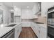 Well-equipped kitchen with stainless steel appliances, quartz countertops, an island, and ample cabinet space at 482 Broom Dr, Cumming, GA 30040