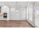 Open concept kitchen featuring stainless steel appliances, a stylish chandelier, and a view of the backyard at 482 Broom Dr, Cumming, GA 30040
