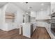 Modern kitchen featuring an island, quartz countertops, stainless steel appliances, and chic pendant lighting at 482 Broom Dr, Cumming, GA 30040
