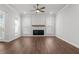 Cozy living room with a fireplace, wood flooring, lots of natural light from several windows at 482 Broom Dr, Cumming, GA 30040