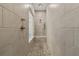 Modern shower with pebble floor and tiled walls featuring a built-in bench at 482 Broom Dr, Cumming, GA 30040