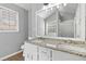 Bathroom features granite countertops, double vanity, and a large mirror at 1055 Leighs Brook Way, Dacula, GA 30019