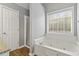 Bathroom with soaking tub, shower, and granite countertop vanity at 1055 Leighs Brook Way, Dacula, GA 30019