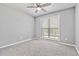 Bedroom with ceiling fan and grey carpet at 1055 Leighs Brook Way, Dacula, GA 30019