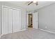 Spacious bedroom with neutral walls and carpet, featuring a double door closet and access to a bathroom at 1055 Leighs Brook Way, Dacula, GA 30019