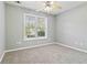 Bright bedroom with carpeted floors and a large window at 1055 Leighs Brook Way, Dacula, GA 30019