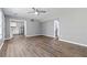 Open living room with wood-look vinyl flooring and access to kitchen at 1055 Leighs Brook Way, Dacula, GA 30019