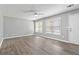 Living room with wood-look vinyl flooring, neutral gray walls, and a ceiling fan at 1055 Leighs Brook Way, Dacula, GA 30019