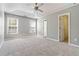 Large main bedroom with ceiling fan, two windows, and access to bathroom and closet at 1055 Leighs Brook Way, Dacula, GA 30019