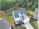 Aerial view of a house with a fenced-in yard and mature trees at 3406 Ravensworth Nw Trce, Kennesaw, GA 30144