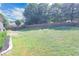 Large grassy backyard with a wooden fence and mature trees at 3406 Ravensworth Nw Trce, Kennesaw, GA 30144
