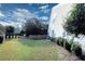 Wide view of a shady, fenced backyard with healthy grass and green shrubbery at 3406 Ravensworth Nw Trce, Kennesaw, GA 30144