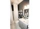 Well-lit bathroom with a shower, toilet, decorative shelves, and a sleek vanity at 3406 Ravensworth Nw Trce, Kennesaw, GA 30144