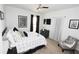 Neutral bedroom with a ceiling fan, soft carpet, and a modern patterned bedspread at 3406 Ravensworth Nw Trce, Kennesaw, GA 30144