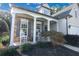 Close-up of covered porch with stone accents, rocking chairs, and well-maintained landscaping at 3406 Ravensworth Nw Trce, Kennesaw, GA 30144