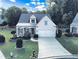Charming home featuring a manicured lawn, covered porch, and a two-car garage at 3406 Ravensworth Nw Trce, Kennesaw, GA 30144