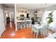Updated kitchen with an island, stainless steel appliances, and a combined dining area with a leafy tree in a pot at 3406 Ravensworth Nw Trce, Kennesaw, GA 30144