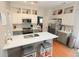 Updated kitchen with stone backsplash, stainless steel appliances, white cabinets, and gray island at 3406 Ravensworth Nw Trce, Kennesaw, GA 30144