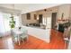 Open-concept living room with fireplace and hardwood floors, adjacent to a dining area at 3406 Ravensworth Nw Trce, Kennesaw, GA 30144